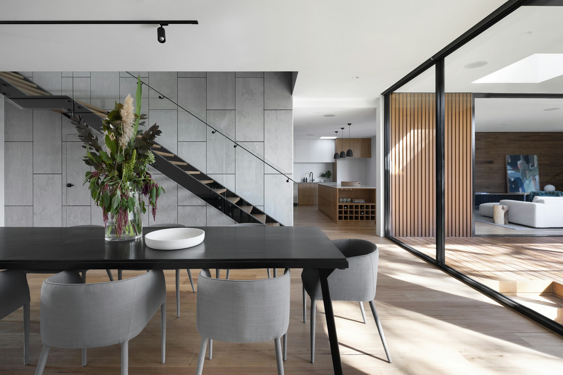 Light-filled interior with neutral stone and natural wood finishes