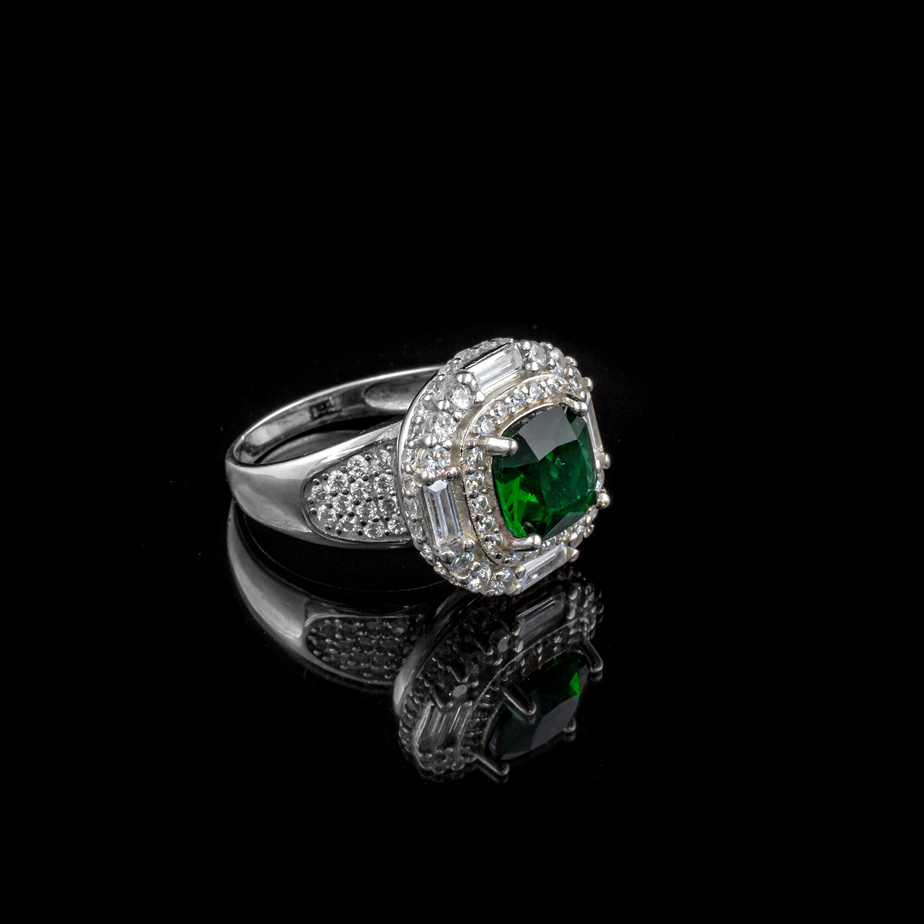 Photographed green-stone ring against a dark background
